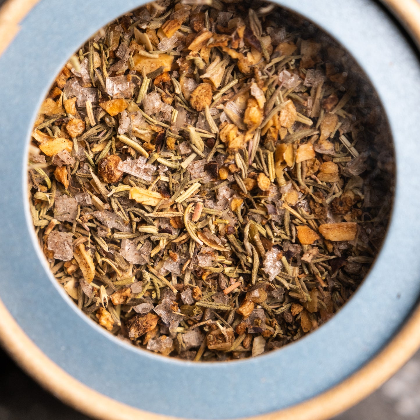 A top down shot of Olsson's Sea Salt Rub showing the sea salt and rosemary